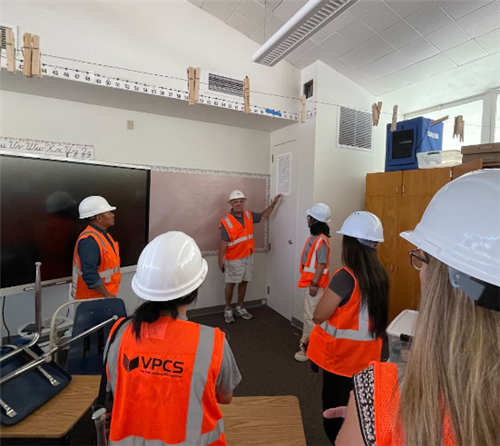 Construction team viewing new HVAC closet in a North classroom